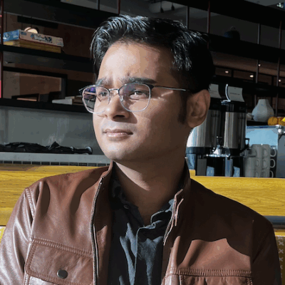 A color photo of a man with glasses.