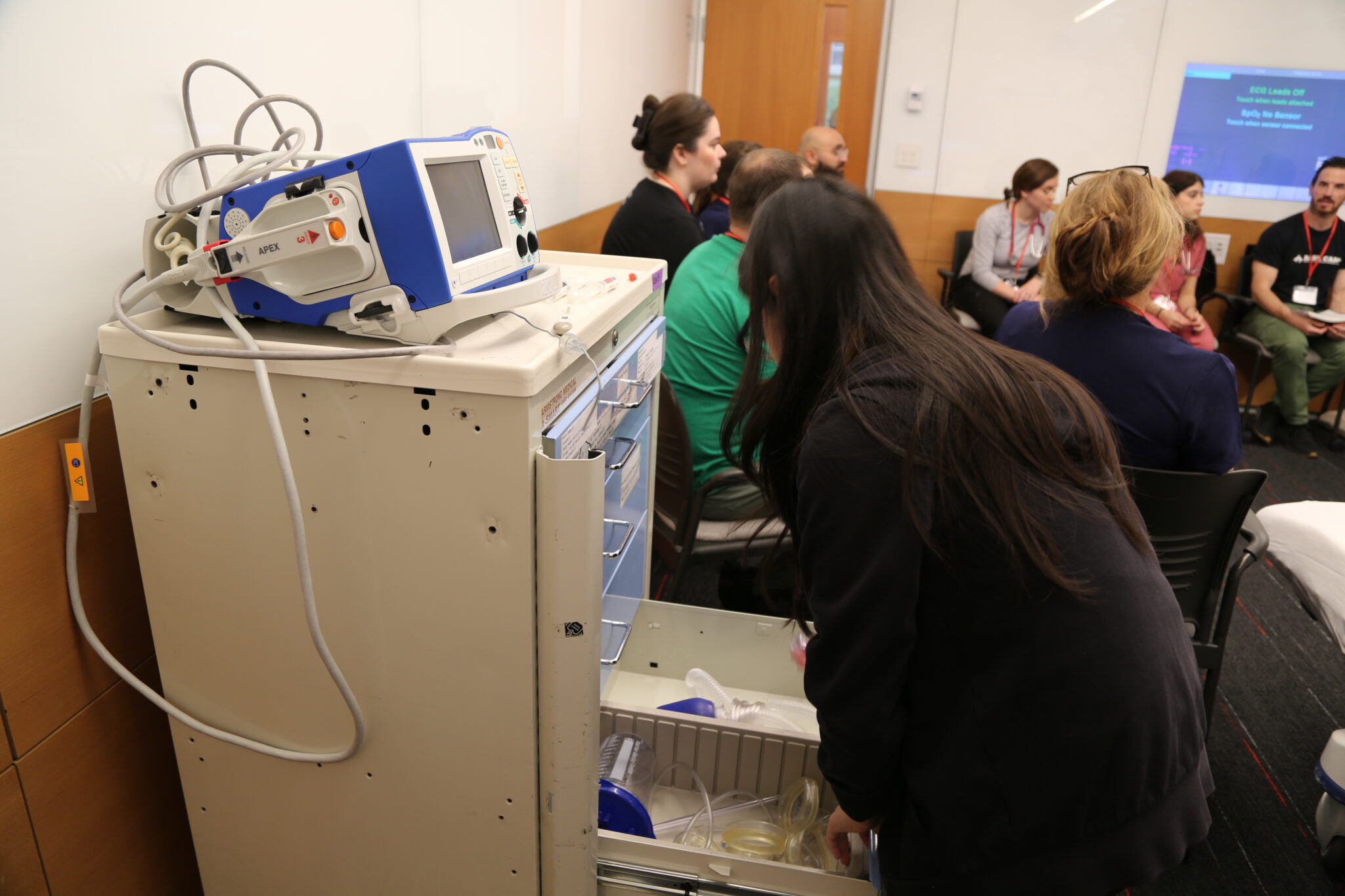 Researcher demo-ing an early prototype of the robotic medical crash cart.