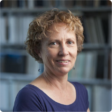 A color photo of a woman smiling for a photo.