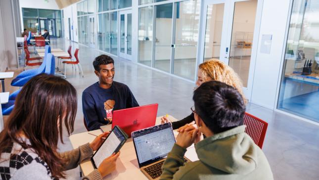 four students work around a tabke
