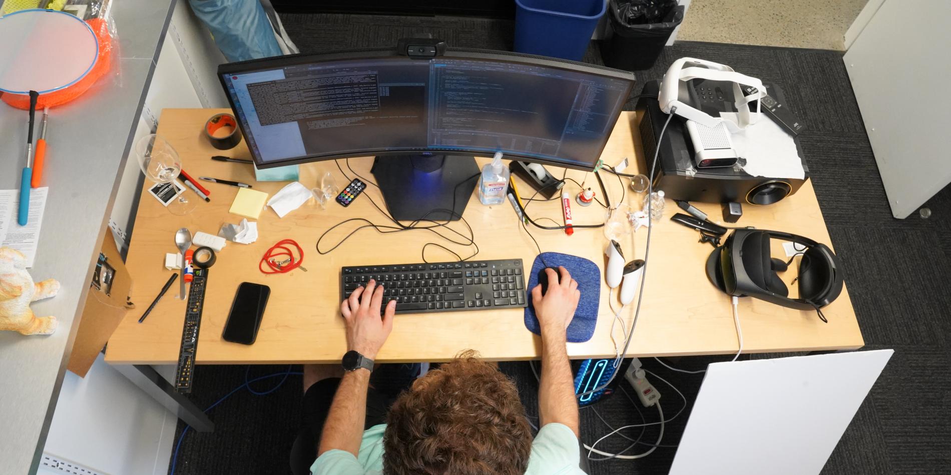 birds eye view of a male student working on a computer at a desk