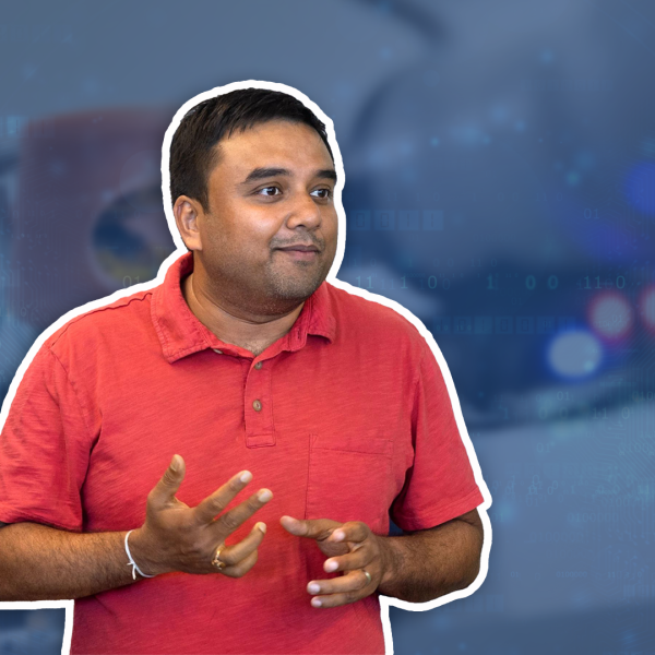 A color photo showing a man wearing a red shirt.