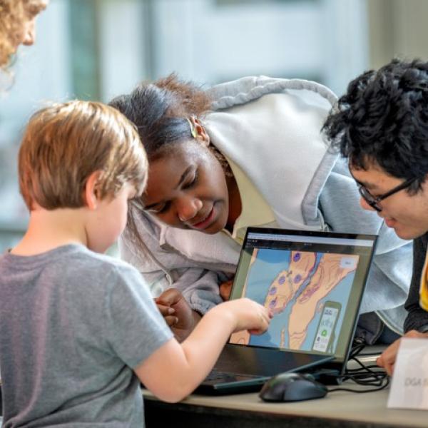 A young guest enjoys some of the technology on display at BOOM 2025.