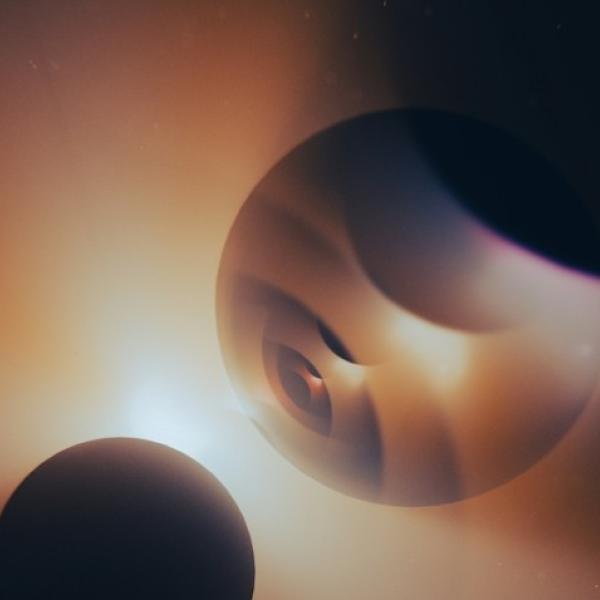 Three spheres near each other, with light behind them