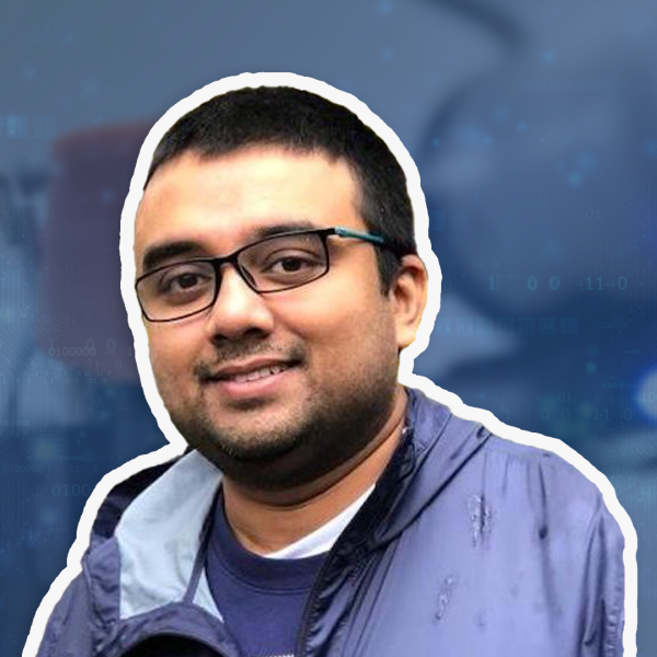 A man with glasses, tan skin and dark short hair smiles in front of a blue overlay background