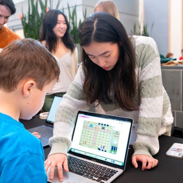 Young attendees try out new video games at BOOM 2024.