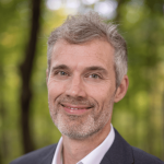 man in suit smiling at the camera