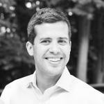 A black and white photo of Ryan Marchenese standing outside