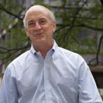 color photo of man in dress shirt smiling