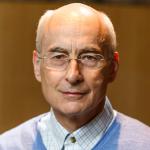 portrait of White man with short white hair and glasses 
