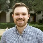 Color portrait Preston Culbertson smiling at the camera; short brown hair wearing checker shirt