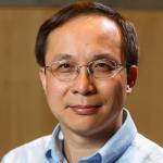 portrait of man with dark hair and glasses