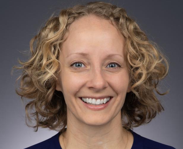 woman with blonde curly hair smiling 