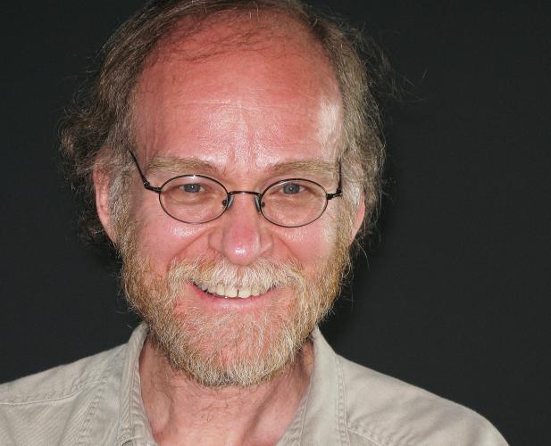 A photo of Joseph Halpern, a man with light brown-white hair, glasses and a beige shirt
