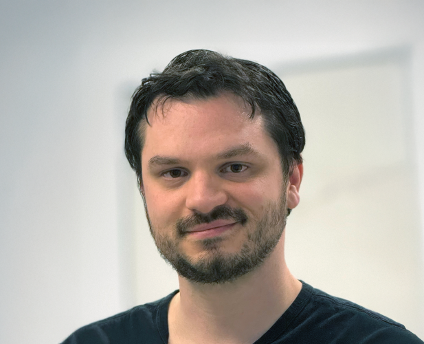 A photo of Abe Davis, a man with dark brown hair.