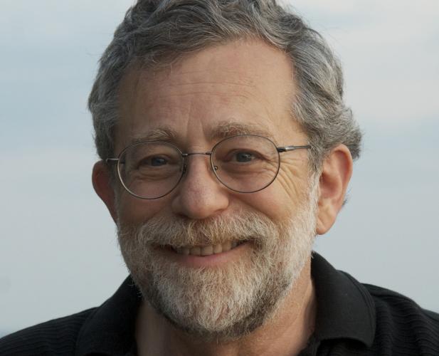 color portrait of main in glasses, greying hair