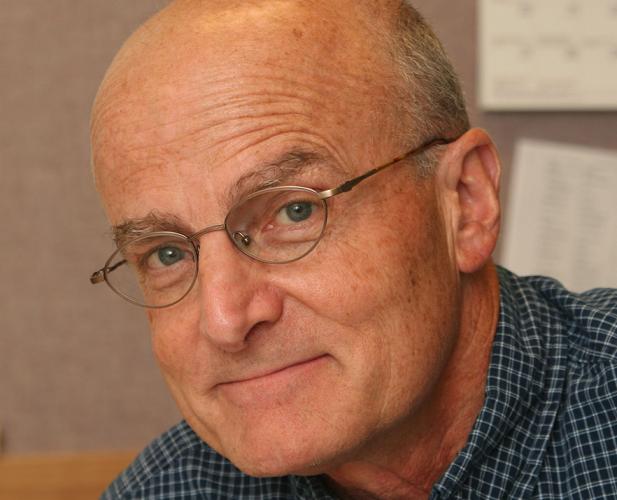 color portrait of man with glasses, greying hair
