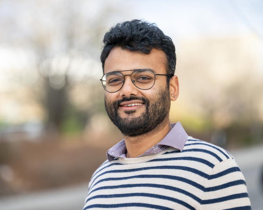 Man with beard and glasses looking at camera, smiling