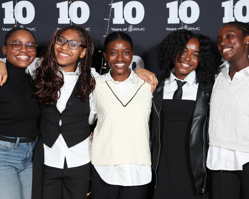 A color photo showing a group of women smiling for a photo.