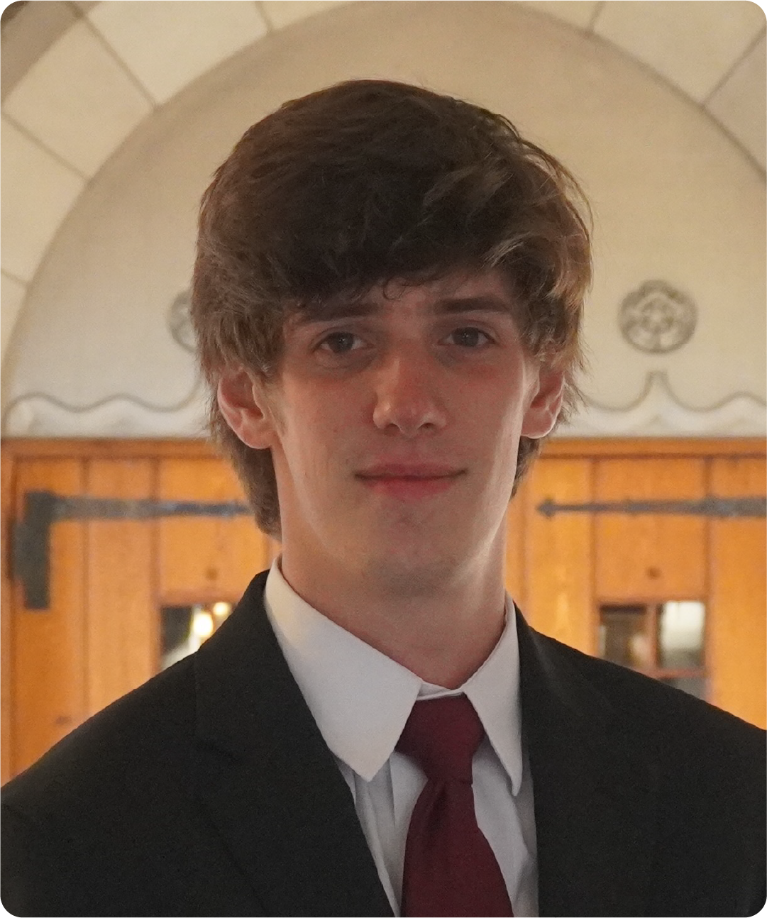 A color photo of a man smiling for a photo.